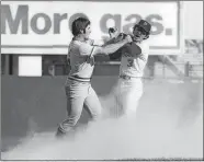  ?? MARTY LEDERHANDL­ER/AP FILE PHOTO ?? Pete Rose, left, of the Cincinnati Reds, swings at New York Mets shortstop Bud Harrelson after Rose failed to break up Harrelson’s double play in Game 3 of the National League Championsh­ip series at Shea Stadium in New York in 1973.