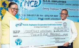  ??  ?? General Manager Joan Garfield presenting a $25,000 education scholarshi­p cheque to Courtney Hanchard, one of the recipients who received outstandin­g grades in GSAT.