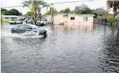  ?? SUSANSTOCK­ER/SOUTHFLORI­DASUNSENTI­NEL ?? Acarmakes itsway through highwaterM­onday on North 64thAvenue near Sheridan Street in Hollywood.