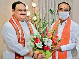  ?? — DC ?? BJP president J.P. Nadda receives a bouquet from former minister Etala Rajendar, who later joined the party in New Delhi on Monday.