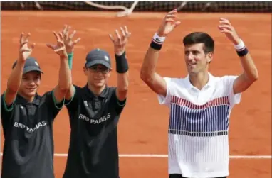  ?? CHRISTOPHE ENA — THE ASSOCIATED PRESS ?? Novak Djokovic celebrates following his 6-3, 6-4, 6-2, win over Marcel Granollers in the first round match of the French Open on Monday.