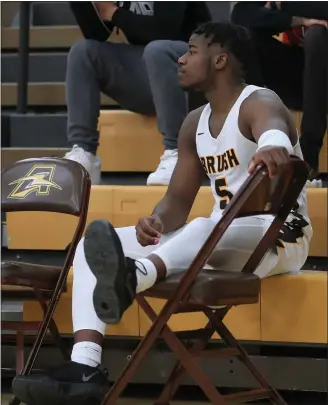  ?? TIM PHILLIS — FOR THE NEWS-HERALD ?? Brush’s Elmore James watches from the bench area during the fourth quarter of the Arcs’ win against Cleveland Central Catholic on Jan. 24 at the Chet Mason Invitation­al at Brush High School.