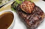  ?? ?? A 16-ounce New York strip steak comes with chile pequin au poivre sauce — foie gras is an option — at Landrace.