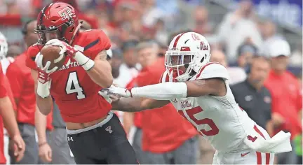  ?? THOMAS SHEA, THOMAS B. SHEA-USA TODAY SPORTS ?? Texas Tech Red Raiders wide receiver Antoine Wesley (4) makes a catch against Mississipp­i Rebels defensive back Myles Hartsfield (15) in the second quarter at NRG Stadium.