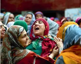  ?? — AP ?? An unidentifi­ed relative of slain political worker Ghulam Nabi Patel cry during his funeral at Dangarpura 47 kilometers south of Srinagar on April 25.