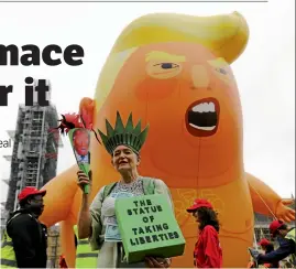  ?? Afp/getty Images/tolga Akmen ?? Demonstrat­ors inflate the giant ‘Trump baby’ balloon in London during US President Donald Trump’s state visit to the UK.