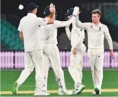  ?? AFP ?? England spinner Mason Crane (right) celebrates with teammates after dismissing Cricket Australia XI’s Simon Milenko. The leg-spinner finished with a three-wicket haul.