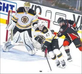  ?? Lenny I gnelzi
Associated Press ?? DUCKS CENTER Brandon Pirri chases Boston defenseman Torey Krug around the net as goalie Jonas Gustavsson watches. The Ducks beat the Bruins, 4- 0.