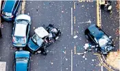  ??  ?? Police at the scene of the fatal crash in Sheffield, South Yorks, and, above, an aerial view following the incident in which four people lost their lives