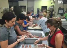  ?? Presentati­on of Christ Church ?? Volunteers shape meatballs in preparatio­n for last year’s food festival at Presentati­on of Christ (Ypapanti) Church in East Pittsburgh. This year’s festival will be held to-go style.