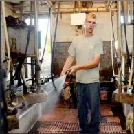  ??  ?? AP/HEATHER AINSWORTH
Dan Dimon, 28, works in the milking parlor at The Carley Farms in Pompey, N.Y.