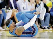  ?? [AP PHOTO] ?? Thunder forward Carmelo Anthony suffered a sprained ankle in the first half of Oklahoma City’s 125-105 win Tuesday night at Golden State.