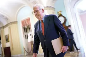  ?? The Associated Press ?? ■ Senate Minority Leader Mitch McConnell, R-Ky., walks to the chamber for a test vote on a government spending bill, at the Capitol in Washington on Monday.