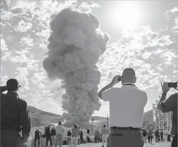  ?? Bill Ingalls NASA ?? GUESTS WATCH a test for NASA’s Space Launch System booster last year at an Orbital facility in Utah. Orbital has a contract with NASA to ferry supplies via its Antares rocket to the Internatio­nal Space Station.