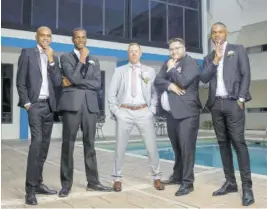  ?? ?? Christophe­r (centre) shares the spotlight with his best man Dennis Whiteway (second right) and groomsmen (from left) the bride’s brother Oneil Mcneil, bride’s cousin Howard Richards, and bride’s uncle Christon Wiggins.