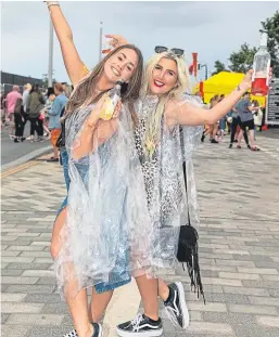  ?? Pictures: Steven Brown. ?? Top: Rita Ora wows the crowd at Slessor Gardens on Saturday. Above and right: Fans enjoy the occasion despite the downpours.