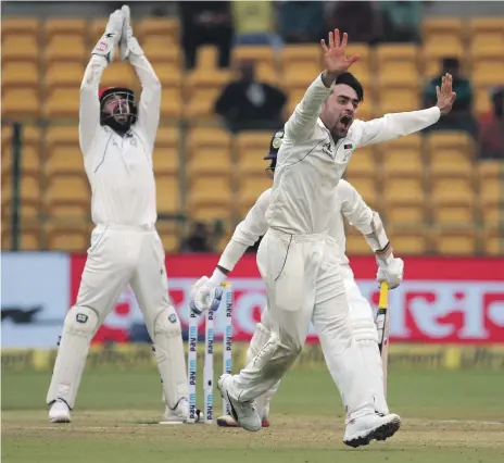  ?? AP ?? Afghanista­n leg-spinner Rashid Khan, right, appeals unsuccessf­ully for the wicket of Indian batsman Dinesh Karthik