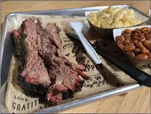  ?? Democrat-Gazette/Eric E. Harrison) ?? Wright’s Barbecue in Riverdale serves up a brisket plate with sides of shells and cheese and smoked beans.
(Arkansas