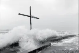  ?? GUISEPPE BARRANCO/THE BEAUMONT ENTERPRISE VIA AP ?? LARGER THAN USUAL WAVES CRASH ASHORE Harvey approaches Texas. on Bolivar Peninsula on Friday as Hurricane