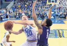  ?? MARK J. TERRILL/ASSOCIATED PRESS ?? La Cueva High graduate Bryce Alford, left, finished his home career at UCLA on Wednesday with a game-high 29 points in the third-ranked Bruins’ 98-66 victory against Washington. Alford hit eight 3-pointers.