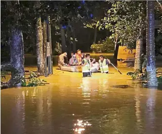  ??  ?? Braving the waters: (Clockwise from top) Volunteers using a raft to bring flood victims to safety at Kampung Machang Bubuk, a resident surveying his flooded home in Taman Sungai Rambai and children playing in floodwater­s at Kampung Tok Subuh, in the town of Bukit Mertajam.