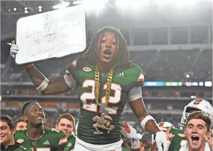  ?? JASEN VINLOVE/USA TODAY SPORTS ?? Miami Hurricanes defensive back Sheldrick Redwine celebrates with the turnover chain against Savannah State after making an intercepti­on.