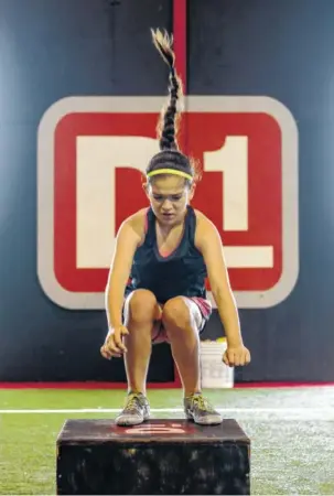  ?? STAFF PHOTO BY DOUG STRICKLAND ?? Aislinn Jimenez jumps onto a box during a training session at D1 Sports Training on Commons Boulevard on Friday in Chattanoog­a. The training facility is under new ownership and is in the process of being renovated.