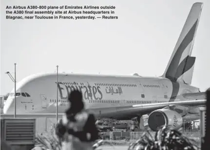  ??  ?? An Airbus A380-800 plane of Emirates Airlines outside the A380 final assembly site at Airbus headquarte­rs in Blagnac, near Toulouse in France, yesterday. — Reuters