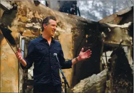  ?? CHRISTOPHE­R CHUNG — THE PRESS DEMOCRAT ?? Gov. Gavin Newsom speaks at a press conference while touring areas damaged by the Glass Fire at Foothills Elementary School near St. Helena.