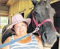  ?? MILLICENT MCKAY/JOURNAL PIONEER ?? Karen Chapman pets horse Cinderella’s Fantasy at the Grand River Ranch. Heather Blouin and her husband run the ranch. They offer services for those with special needs to come to the ranch and learn new skills.