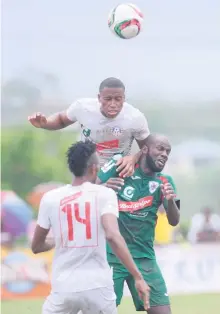  ?? FILE ?? Portmore United’s Damono Solomon (top) heads the ball away from Humble Lion’s Francois Swaby while Portmore’s Osani Rickett’s look’s on in their Red Stripe Premier League encounter at the Effortvill­e Community Centre on Sunday, October 4, 2016.