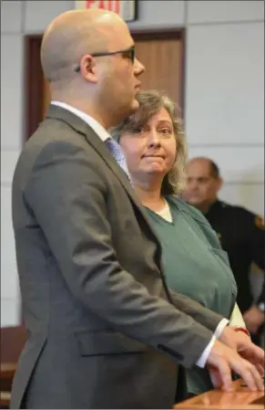  ?? ERIC BONZAR — THE MORNING JOURNAL ?? Janet Tyburski, of Lakewood, appears in Lorain County Common Pleas Court Judge John Miraldi’s courtroom, alongside her attorney Nicholas Hanek, April 5. Tyburski, 47, pleaded guilty to an amended indictment, and was sentenced to 19 years to life for...