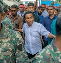  ?? AP ?? Yameen Abdul Gayoom, centre, surrounded by his body guards, arrives to address his supporters in Male, Maldives. —