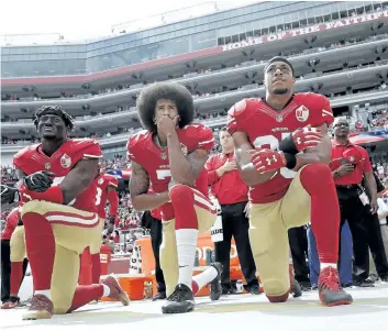  ?? MARCIO JOSE SANCHEZ/AP FILES ?? San Francisco 49ers Eli Harold, from left, Colin Kaepernick and Eric Reid kneel during the national anthem in this October 2016 file photo. Kaepernick, who spearheade­d the protest, is without a job as training camps open, despite having a much more...