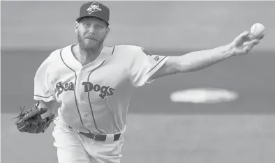  ?? MARY SCHWALM/AP ?? Chris Sale pitches for the Portland Sea Dogs in a July 20 game against the Harrisburg Senators as he rehabs from surgery.