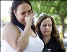  ?? ?? Marisela Cornejo, left, cries alongside Rita Estrada in front of son Manny Huizar's memorial at the Safeway.