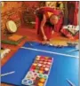  ?? BOB KEELER — DIGITAL FIRST MEDIA ?? A monk with the Sacred Art Tour of Tibetan Monks lights a candle on the edge of where a sand mandala will be created during the June 13 through 18 visit by the monks to the Yoga Tree at the Pennridge Wellness Center in Blooming Glen.