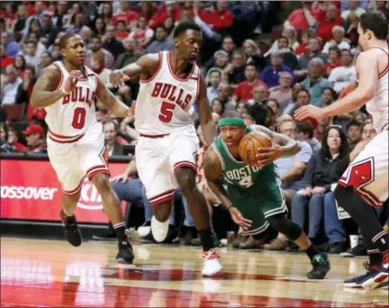 ?? CHARLES REX ARBOGAST — THE ASSOCIATED PRESS ?? The Celtics’ Isaiah Thomas (4) dribbles through the Bulls defense during the first half in Game 4 on Sunday.