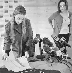  ??  ?? Tintori places documents on the table before a news conference in Caracas.— Reuters photo