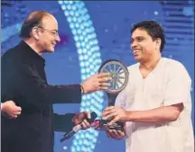  ??  ?? Acharya Balkrishna, managing director of Patanjali Ayurved Ltd, receives the Indian of the Year award in the business category.