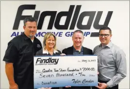  ??  ?? Findlay Automotive Group Findlay Automotive Group Chief Financial Officer Tyler Corder, second from right, and Findlay accounting officer Chad Leavitt, right, present a check for $7,000 to Goodie Two Shoes founders Tony and Nikki Berti.