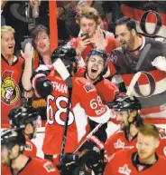  ?? Adrian Wyld / Associated Press ?? Ottawa’s Jean-Gabriel Pageau (center) celebrates his double-OT game-winning goal with teammates.