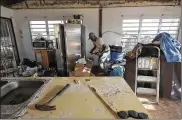  ?? BONNIE JO MOUNT / WASHINGTON POST ?? Desmond Proctor, 72, works on his daughter’s home Jan. 21 in St. Thomas, U.S. Virgin Islands. After enduring back-toback Category 5 hurricanes in September, residents say they have a better understand­ing about the fragility of their natural environmen­t.