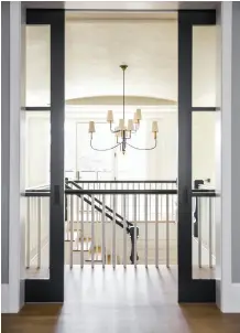  ??  ?? Colour and Calm In the master (left), Brown designed a space both quiet and full of detail. A rug from Restoratio­n Hardware sets the colour palette for a bold blue accent chair from Mitchell Gold and Bob Williams. On the upper level, the stairwell is...