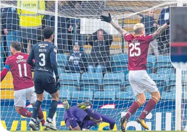  ??  ?? Stephen Dobbie beats Dundee keeper Seny Dieng to put Queen of the South in front, much to the delight of team-mate Lyndon Dykes. Dee defender Nathan Ralph looks on.