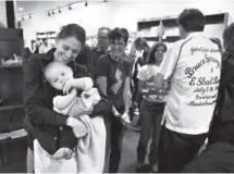  ??  ?? Waverly Kille and her 8-month-old son, August, are the first in line to meet – and take a photo with – Springstee­n, commonly called the Boss.