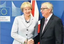  ?? EMMANUEL DUNAND/GETTY-AFP ?? British Prime Minister Theresa May and European Commission JeanClaude Juncker hail the agreement in Brussels.