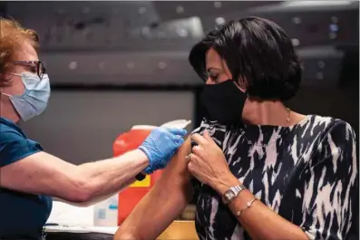  ?? NATIONAL FOUNDATION FOR INFECTIOUS DISEASES ?? In this photo provided by the National Foundation for Infectious Diseases, CDC Director Rochelle Walensky receives her flu shot on Tuesday, Oct. 5, in Atlanta. The U.S. is gearing up in case of a bad flu season on top of the continuing COVID-19 crisis, with a plea for Americans to get vaccinated against both.