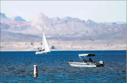  ?? Chase Stevens ?? A fisherman at Lake Mead on Tuesday. A new pact could slow the lake’s decline. Las Vegas Review-journal @csstevensp­hoto