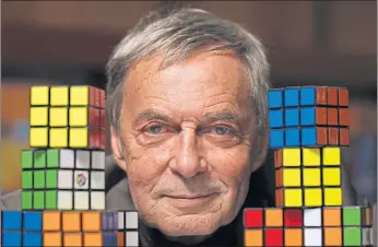  ??  ?? Erno Rubik poses with his famous cube, of which more than 350 million have been sold